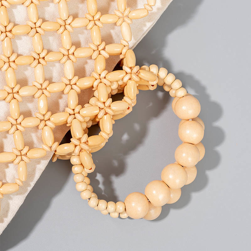 Bolso de cuentas de madera huecas tejidas a mano con hilo de pesca tejida y piedras de Buda