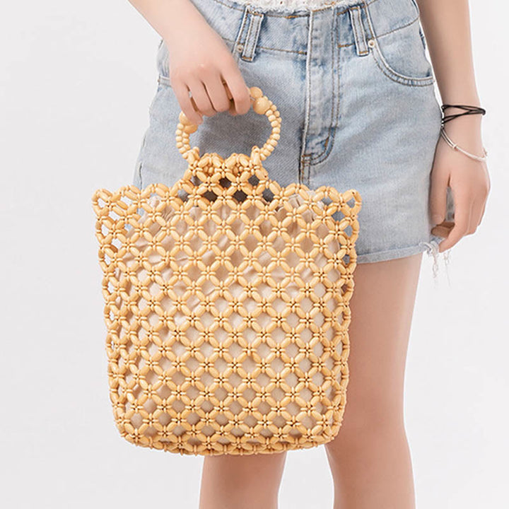 Bolso de cuentas de madera huecas tejidas a mano con hilo de pesca tejida y piedras de Buda