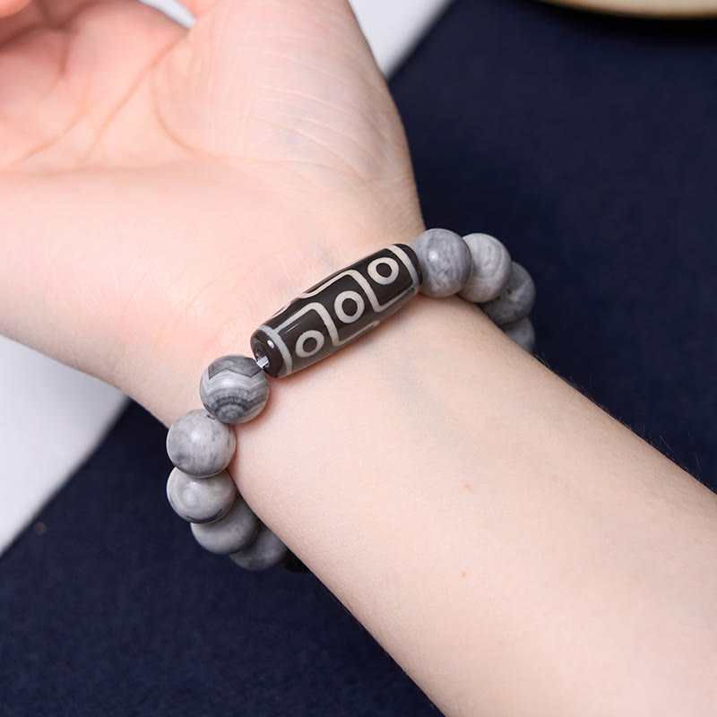 Pulsera positiva de jaspe Picasso con cuentas Dzi tibetanas de nueve ojos con Buddha Stones