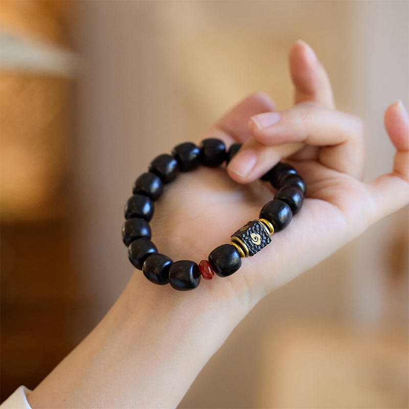Pulsera de calma grabada en madera de ébano con nubes auspiciosas y Buddha Stones