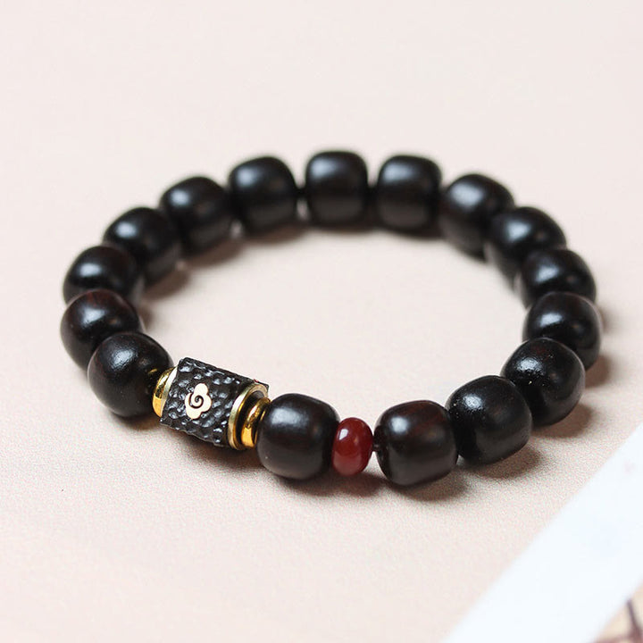Pulsera de calma grabada en madera de ébano con nubes auspiciosas y Buddha Stones