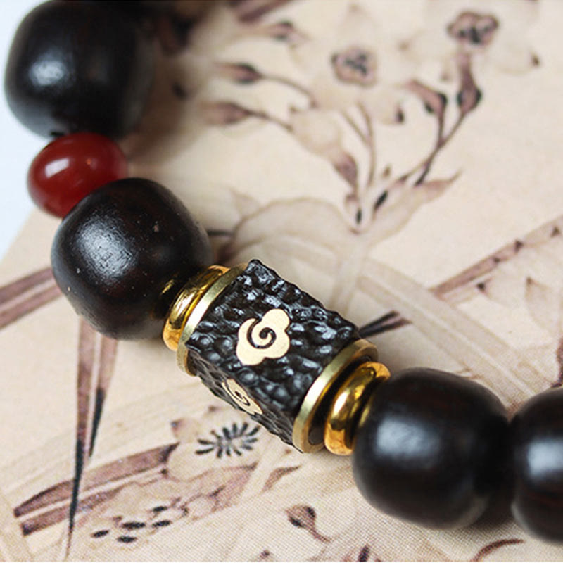 Pulsera de calma grabada en madera de ébano con nubes auspiciosas y Buddha Stones