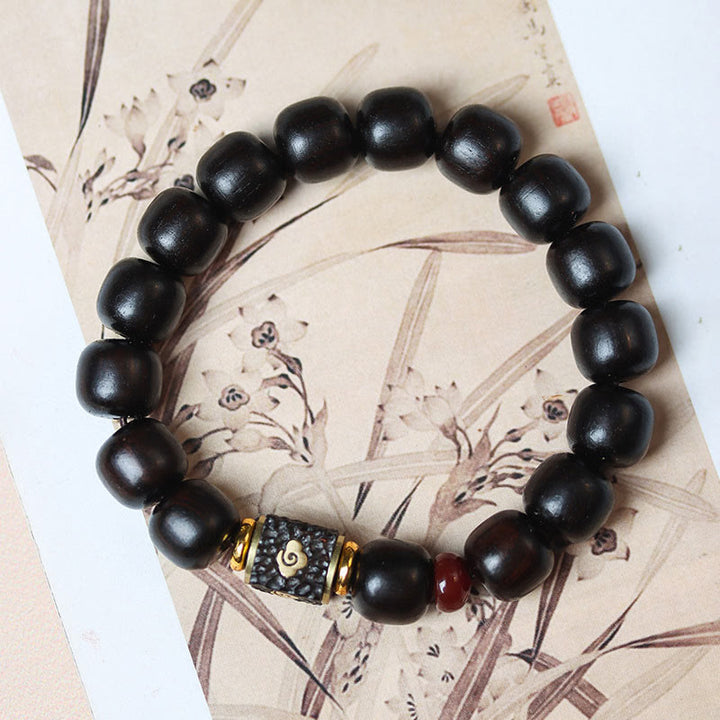 Pulsera de calma grabada en madera de ébano con nubes auspiciosas y Buddha Stones