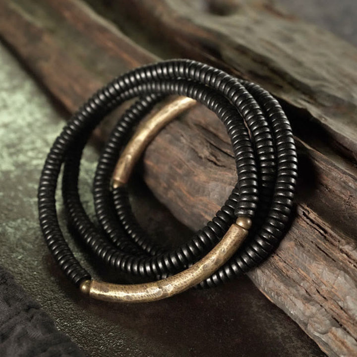 Pulsera multicapa de cuentas de madera de ébano tibetano de Buddha Stones y cobre de la paz