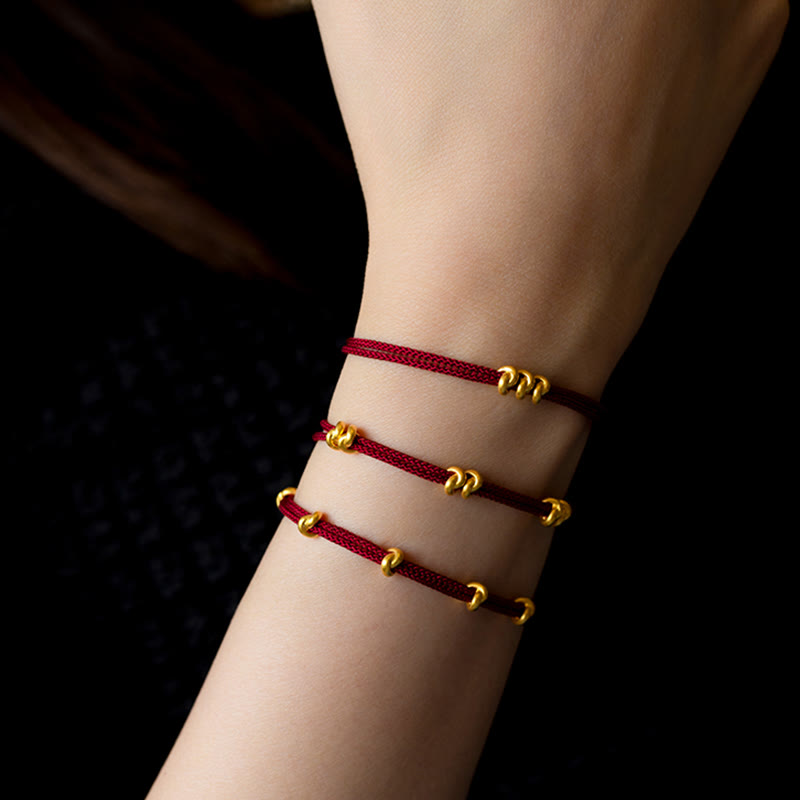 Pulsera trenzada de cuerda con diseño de nudo de los deseos hecha a mano con Buddha Stones en oro 999 - image 0