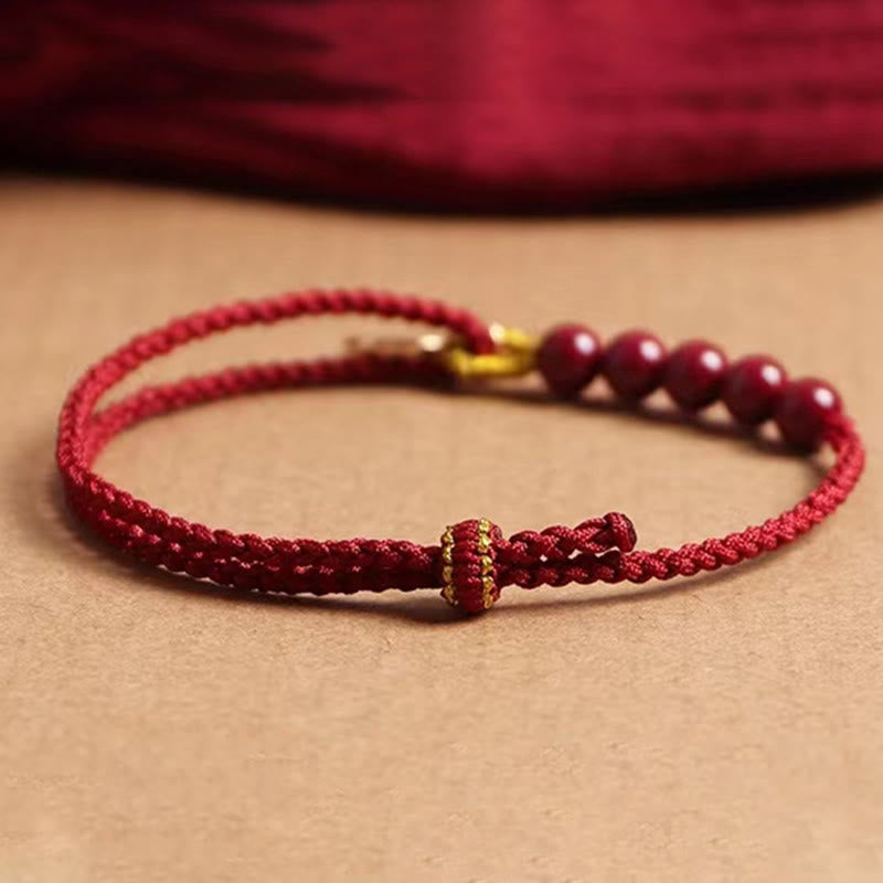 Pulsera trenzada hecha a mano con hilo rojo y cuentas de cinabrio con carácter Fu y Buddha Stones