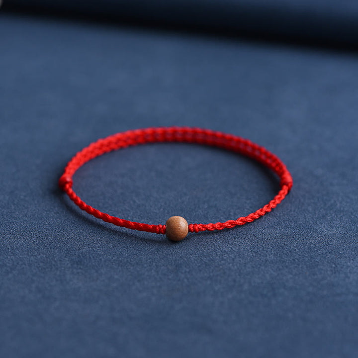 Pulsera trenzada con cuentas de madera de melocotón natural y Buddha Stones que alejan a los malos espíritus