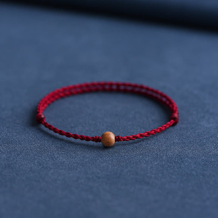 Pulsera trenzada con cuentas de madera de melocotón natural y Buddha Stones que alejan a los malos espíritus