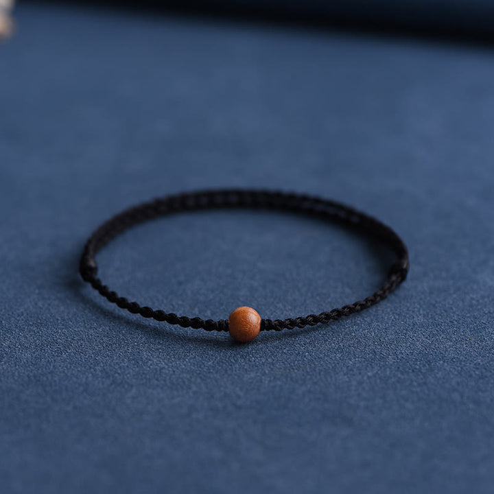 Pulsera trenzada con cuentas de madera de melocotón natural y Buddha Stones que alejan a los malos espíritus
