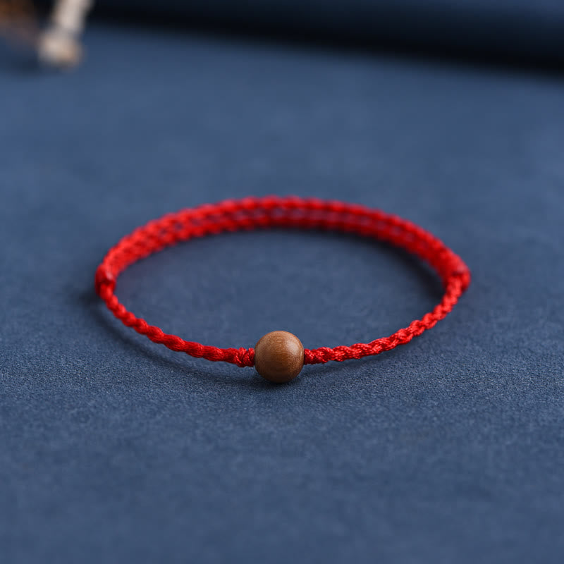 Pulsera trenzada con cuentas de madera de melocotón natural y Buddha Stones que alejan a los malos espíritus