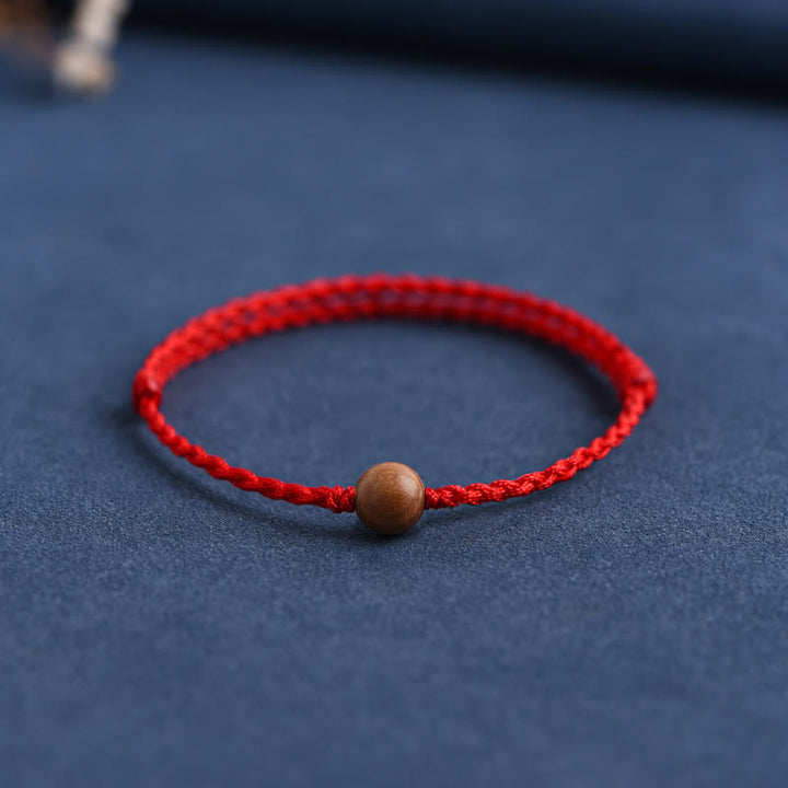 Pulsera trenzada con cuentas de madera de melocotón natural y Buddha Stones que alejan a los malos espíritus