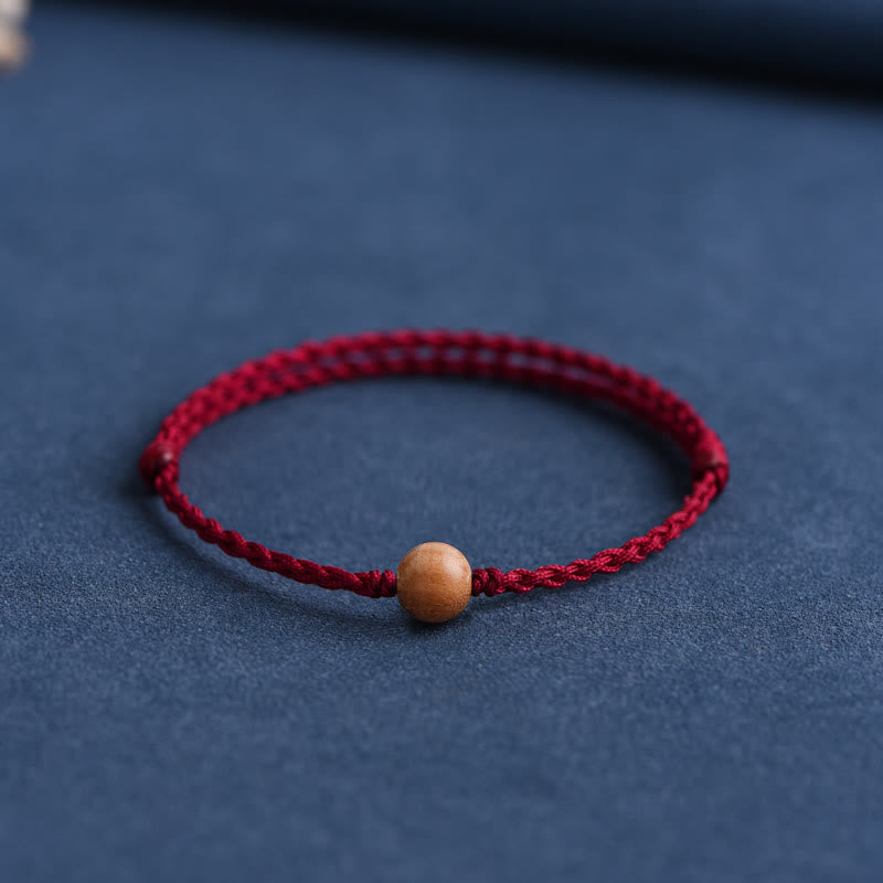 Pulsera trenzada con cuentas de madera de melocotón natural y Buddha Stones que alejan a los malos espíritus