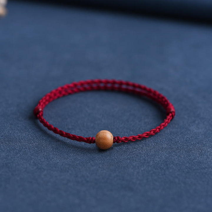Pulsera trenzada con cuentas de madera de melocotón natural y Buddha Stones que alejan a los malos espíritus