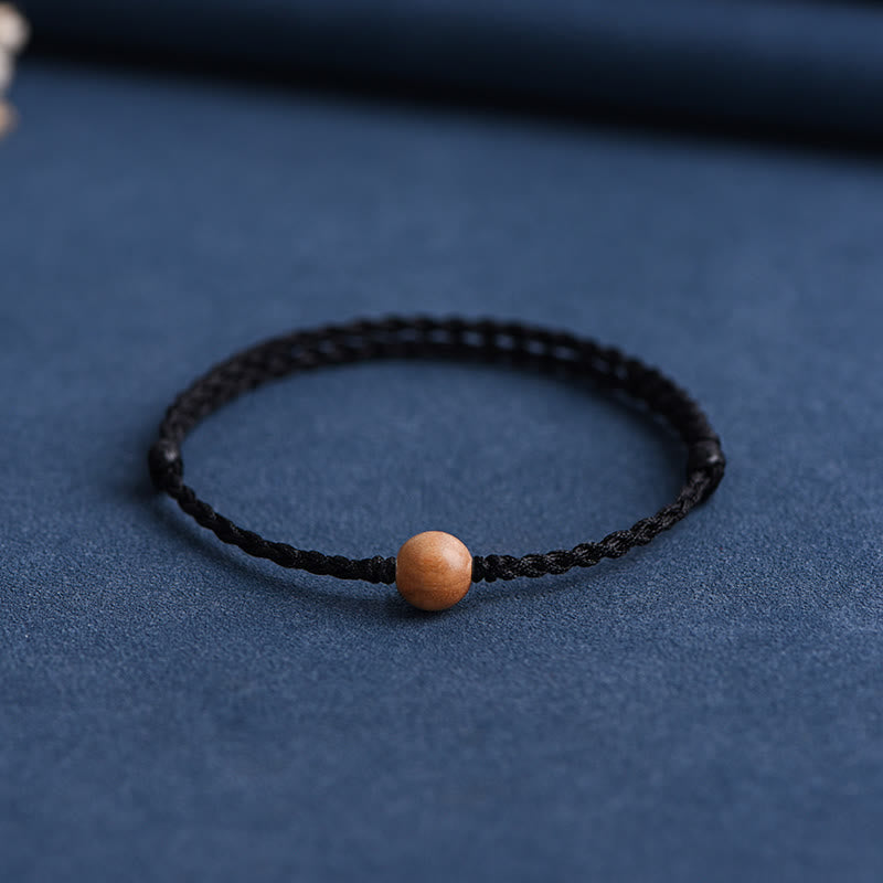Pulsera trenzada con cuentas de madera de melocotón natural y Buddha Stones que alejan a los malos espíritus