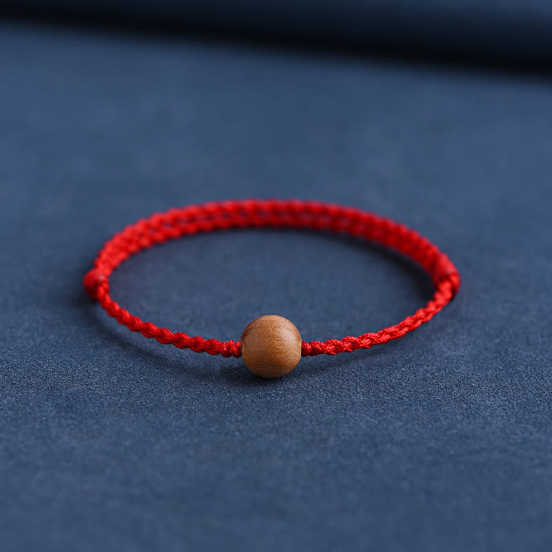 Pulsera trenzada con cuentas de madera de melocotón natural y Buddha Stones que alejan a los malos espíritus