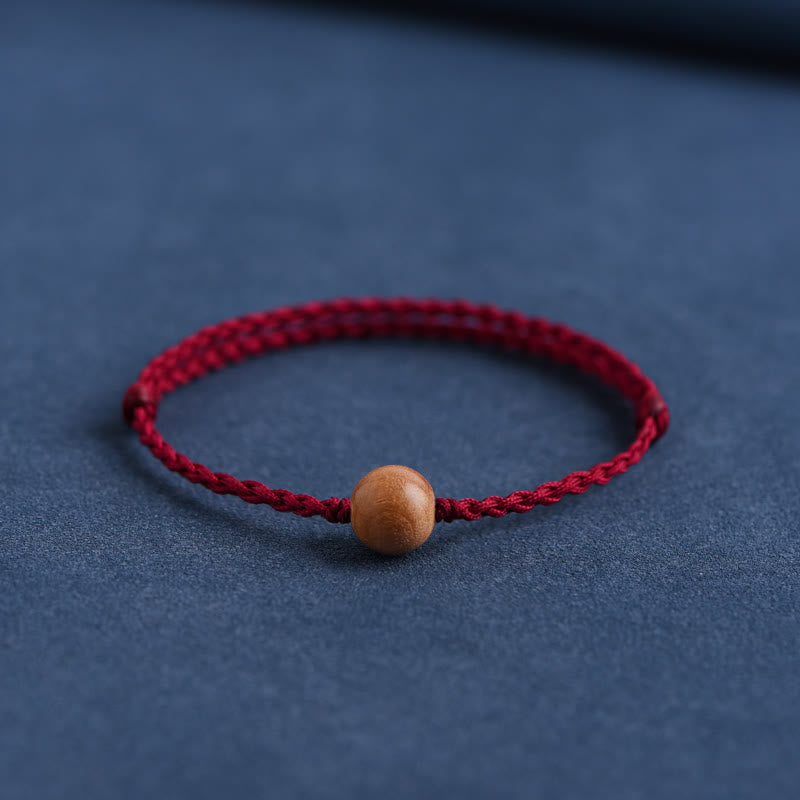 Pulsera trenzada con cuentas de madera de melocotón natural y Buddha Stones que alejan a los malos espíritus