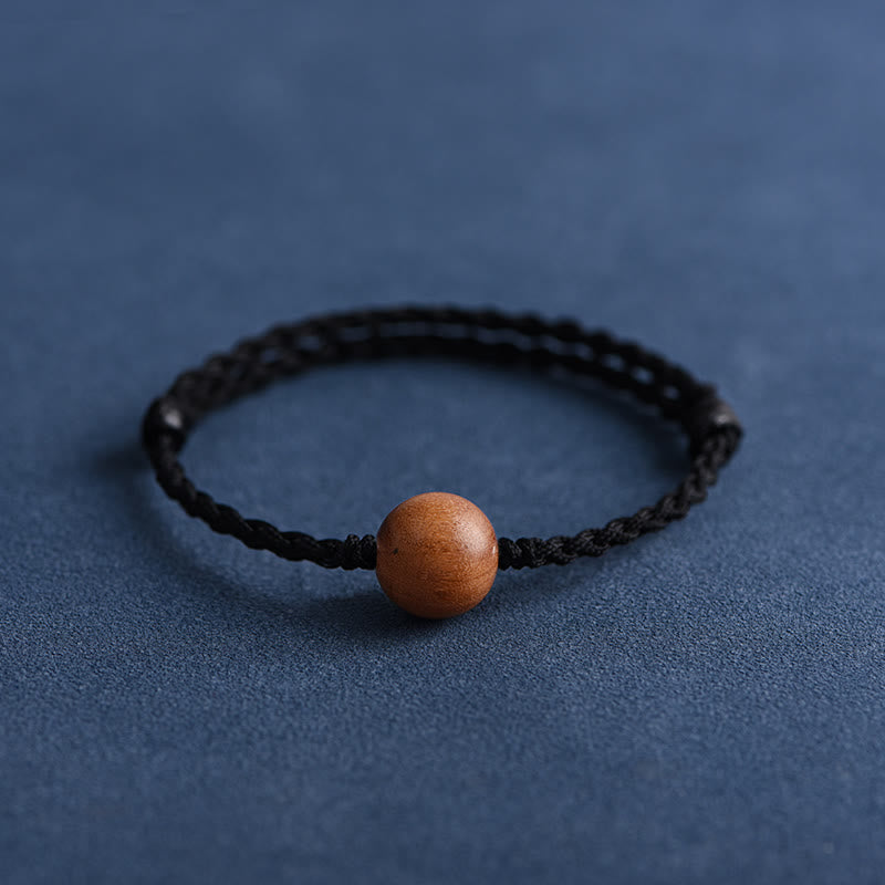 Pulsera trenzada con cuentas de madera de melocotón natural y Buddha Stones que alejan a los malos espíritus