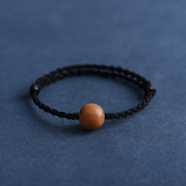 Pulsera trenzada con cuentas de madera de melocotón natural y Buddha Stones que alejan a los malos espíritus