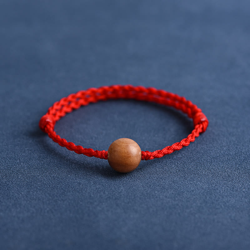 Pulsera trenzada con cuentas de madera de melocotón natural y Buddha Stones que alejan a los malos espíritus