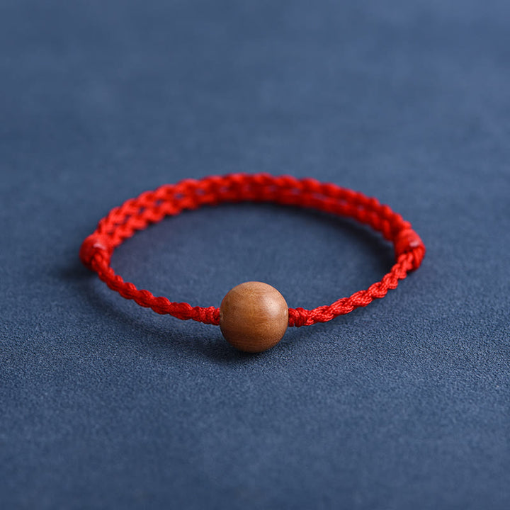 Pulsera trenzada con cuentas de madera de melocotón natural y Buddha Stones que alejan a los malos espíritus