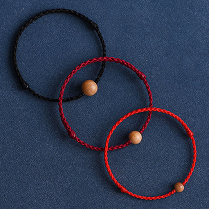 Pulsera trenzada con cuentas de madera de melocotón natural y Buddha Stones que alejan a los malos espíritus