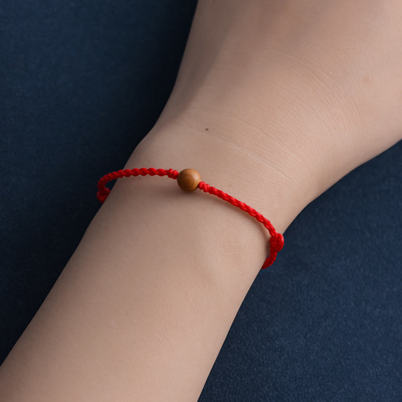 Pulsera trenzada con cuentas de madera de melocotón natural y Buddha Stones que alejan a los malos espíritus