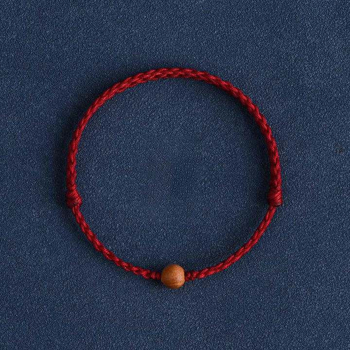 Pulsera trenzada con cuentas de madera de melocotón natural y Buddha Stones que alejan a los malos espíritus