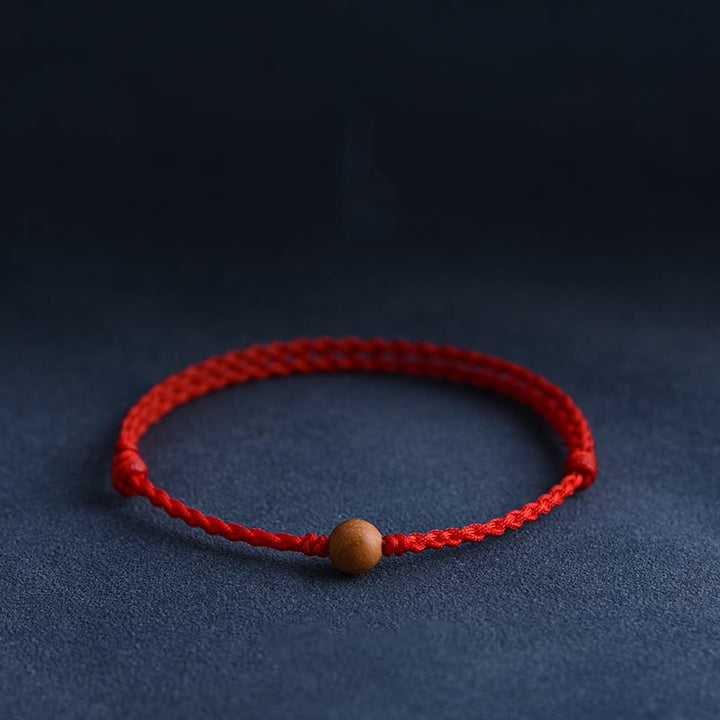 Pulsera trenzada con cuentas de madera de melocotón natural y Buddha Stones que alejan a los malos espíritus