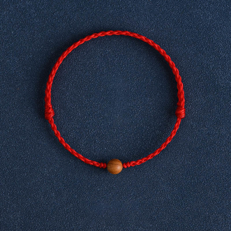 Pulsera trenzada con cuentas de madera de melocotón natural y Buddha Stones que alejan a los malos espíritus