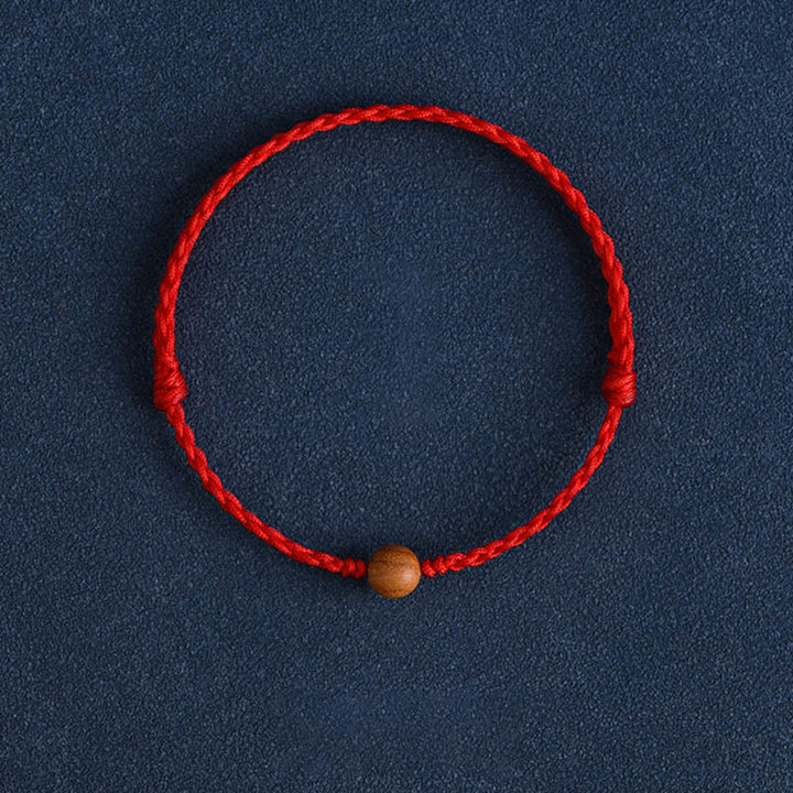 Pulsera trenzada con cuentas de madera de melocotón natural y Buddha Stones que alejan a los malos espíritus
