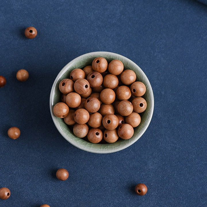 Pulsera trenzada con cuentas de madera de melocotón natural y Buddha Stones que alejan a los malos espíritus