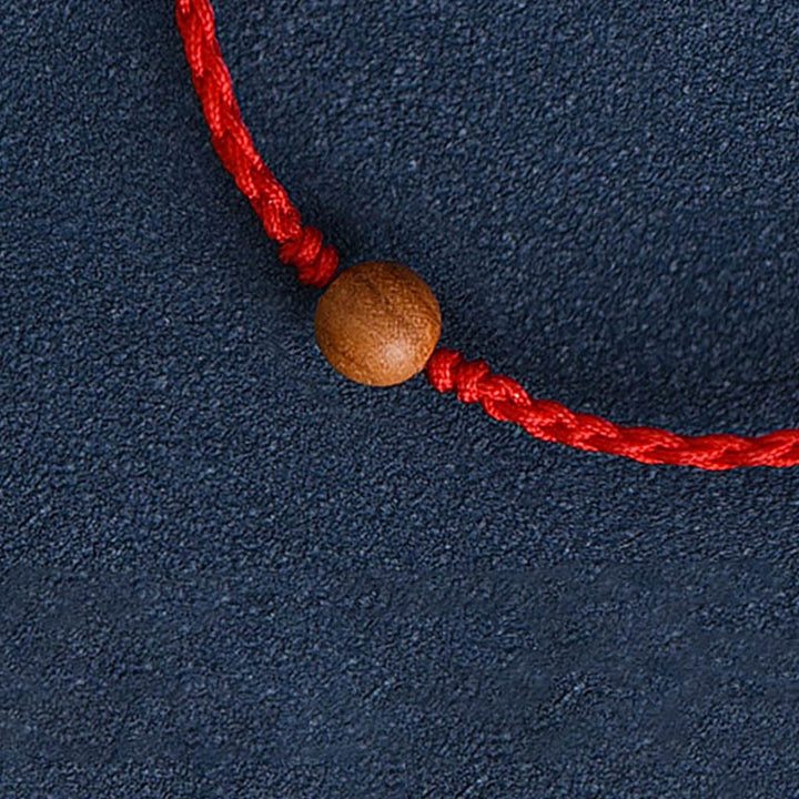 Pulsera trenzada con cuentas de madera de melocotón natural y Buddha Stones que alejan a los malos espíritus