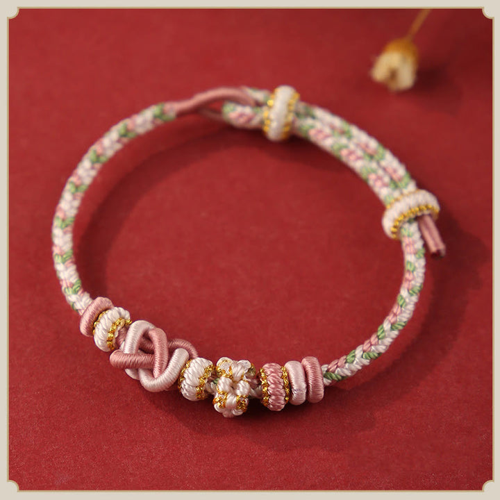 Pulsera ajustable de cuerda colorida con nudo de paz de flor de durazno hecha a mano con Buddha Stones