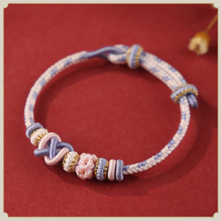 Pulsera ajustable de cuerda colorida con nudo de paz de flor de durazno hecha a mano con Buddha Stones