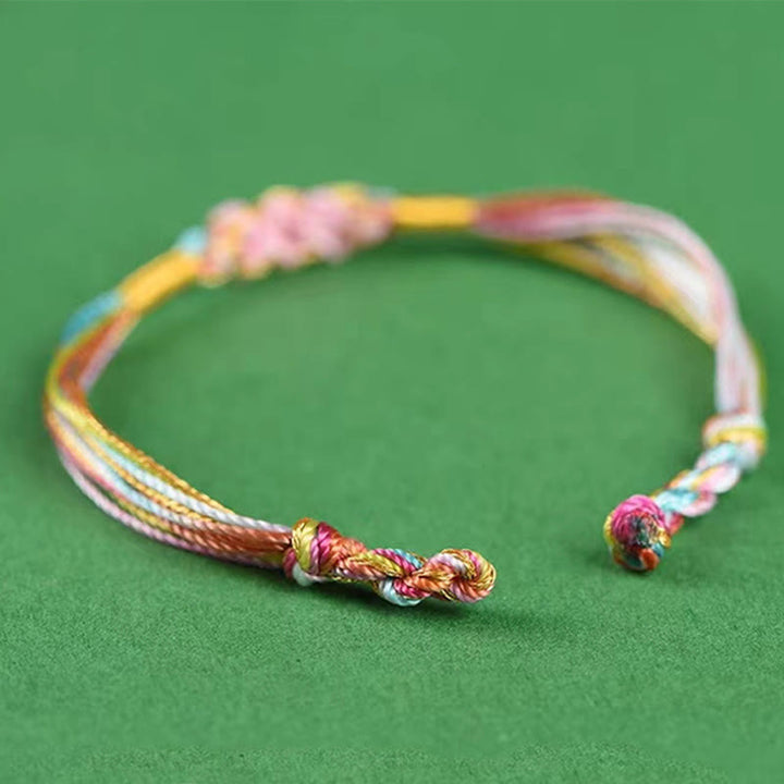 Pulsera trenzada zongzi con nudo de flor de durazno y cuerda colorida de Buddha Stones