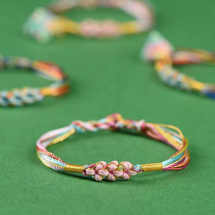 Pulsera trenzada zongzi con nudo de flor de durazno y cuerda colorida de Buddha Stones
