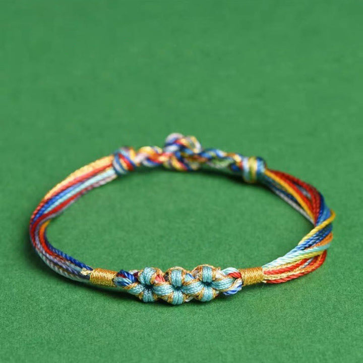 Pulsera trenzada zongzi con nudo de flor de durazno y cuerda colorida de Buddha Stones