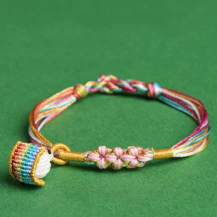 Pulsera trenzada zongzi con nudo de flor de durazno y cuerda colorida de Buddha Stones