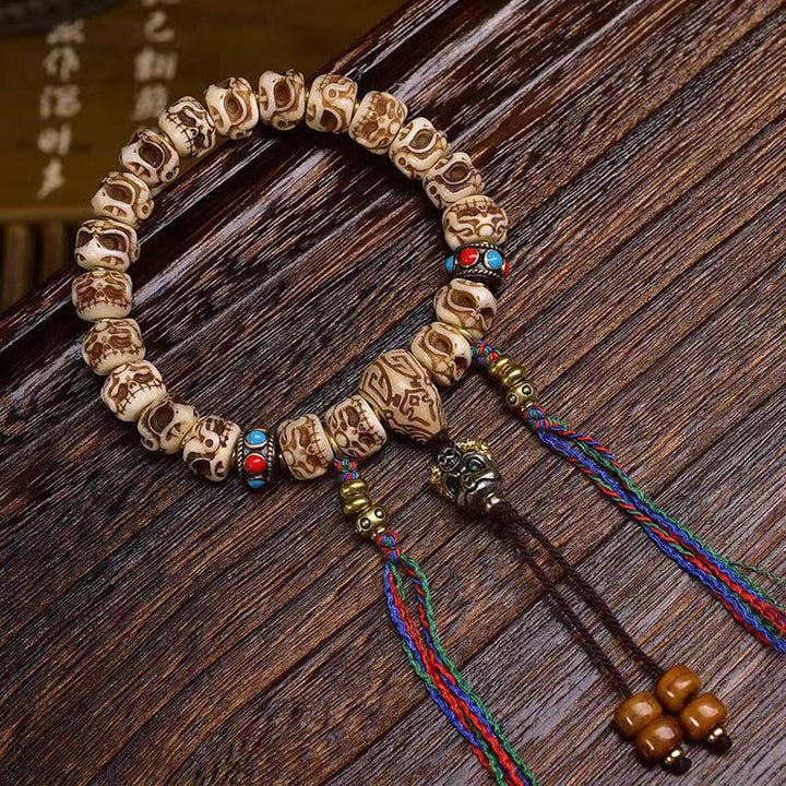 Pulsera de borlas protectoras talladas con garuda de hueso de camello tibetano y Buddha Stones