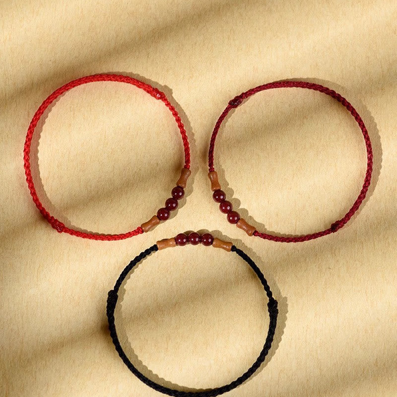 Pulsera de hilo bendecido de madera de melocotón con cuentas de cinabrio y Buddha Stones