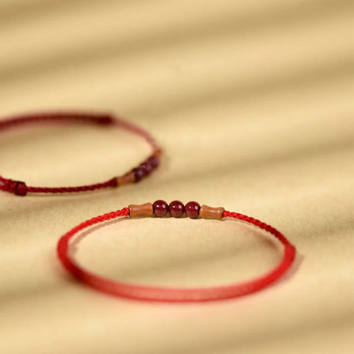 Pulsera de hilo bendecido de madera de melocotón con cuentas de cinabrio y Buddha Stones