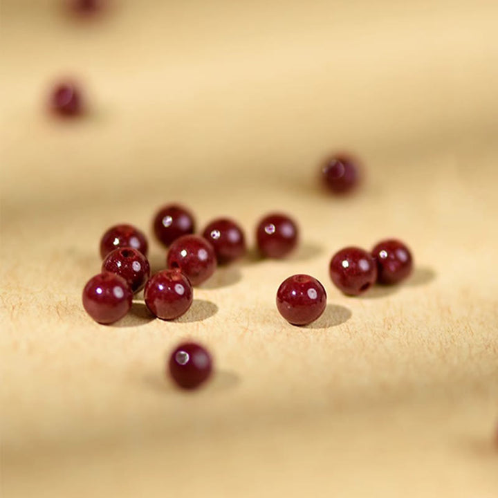 Pulsera de hilo bendecido de madera de melocotón con cuentas de cinabrio y Buddha Stones