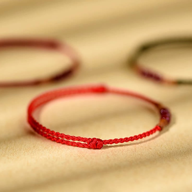 Pulsera de hilo bendecido de madera de melocotón con cuentas de cinabrio y Buddha Stones