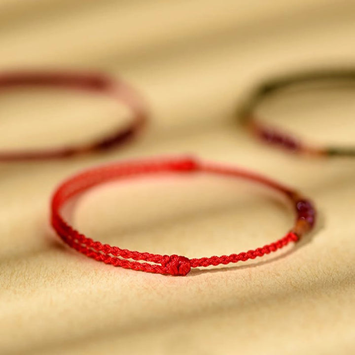 Pulsera de hilo bendecido de madera de melocotón con cuentas de cinabrio y Buddha Stones