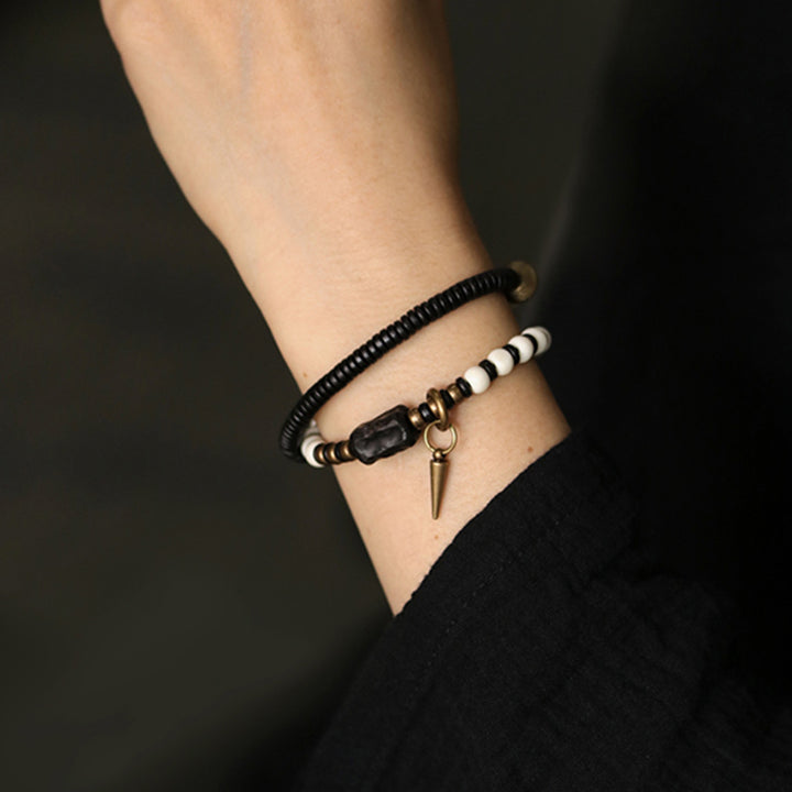Pulsera de pareja con Buddha Stones, cuentas de hueso, madera de ébano y cobre.