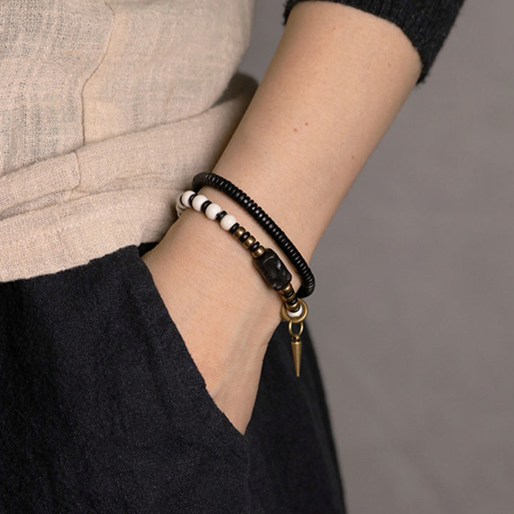 Pulsera de pareja con Buddha Stones, cuentas de hueso, madera de ébano y cobre.