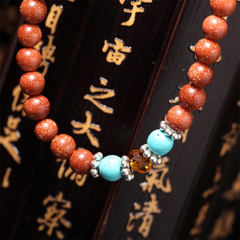 Buddha Stones 108 cuentas Mala Goldstone Om Mani Padme Hum esvástica pulsera de confianza