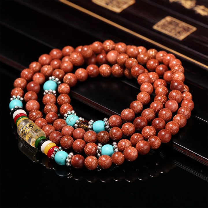 Buddha Stones 108 cuentas Mala Goldstone Om Mani Padme Hum esvástica pulsera de confianza