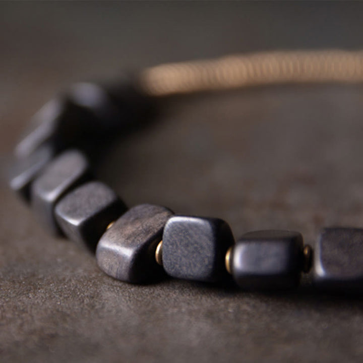 Pulsera de doble envoltura de paz de cobre y madera de ébano tibetano con Buddha Stones