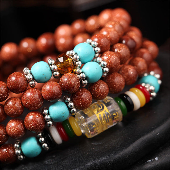 Buddha Stones 108 cuentas Mala Goldstone Om Mani Padme Hum esvástica pulsera de confianza